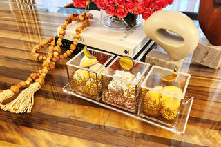 image Gold Moon and Gold Sun Dessert Box with gold printed pattern on Acrylic Tray on dining table setting with books and flowers and decoration.